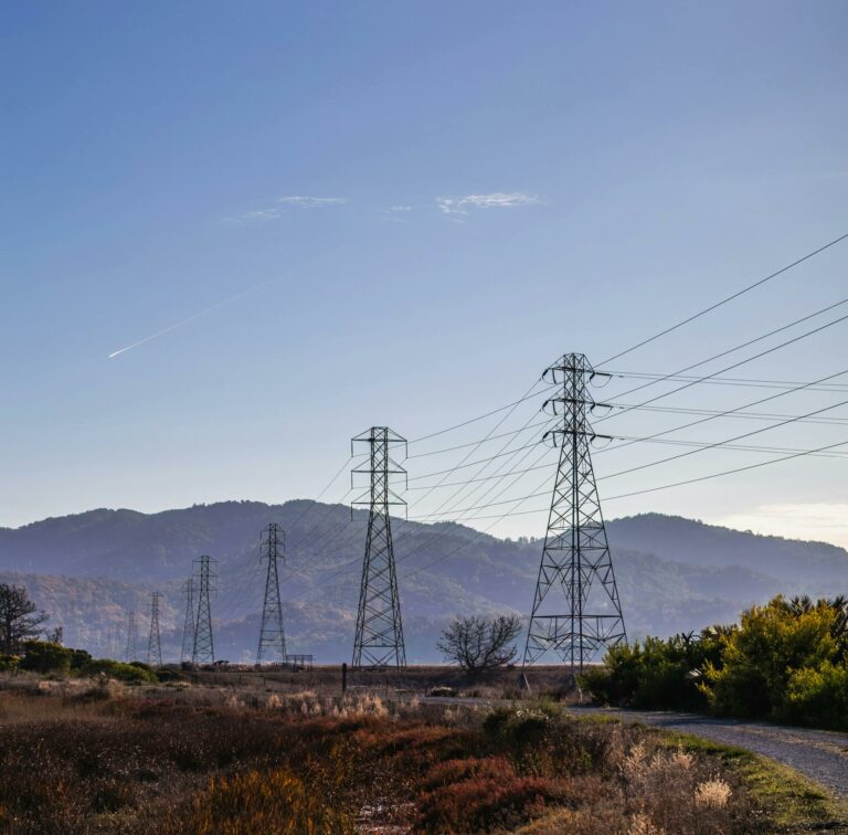 View of a Road along Utility Poles and Mountains in Distance 